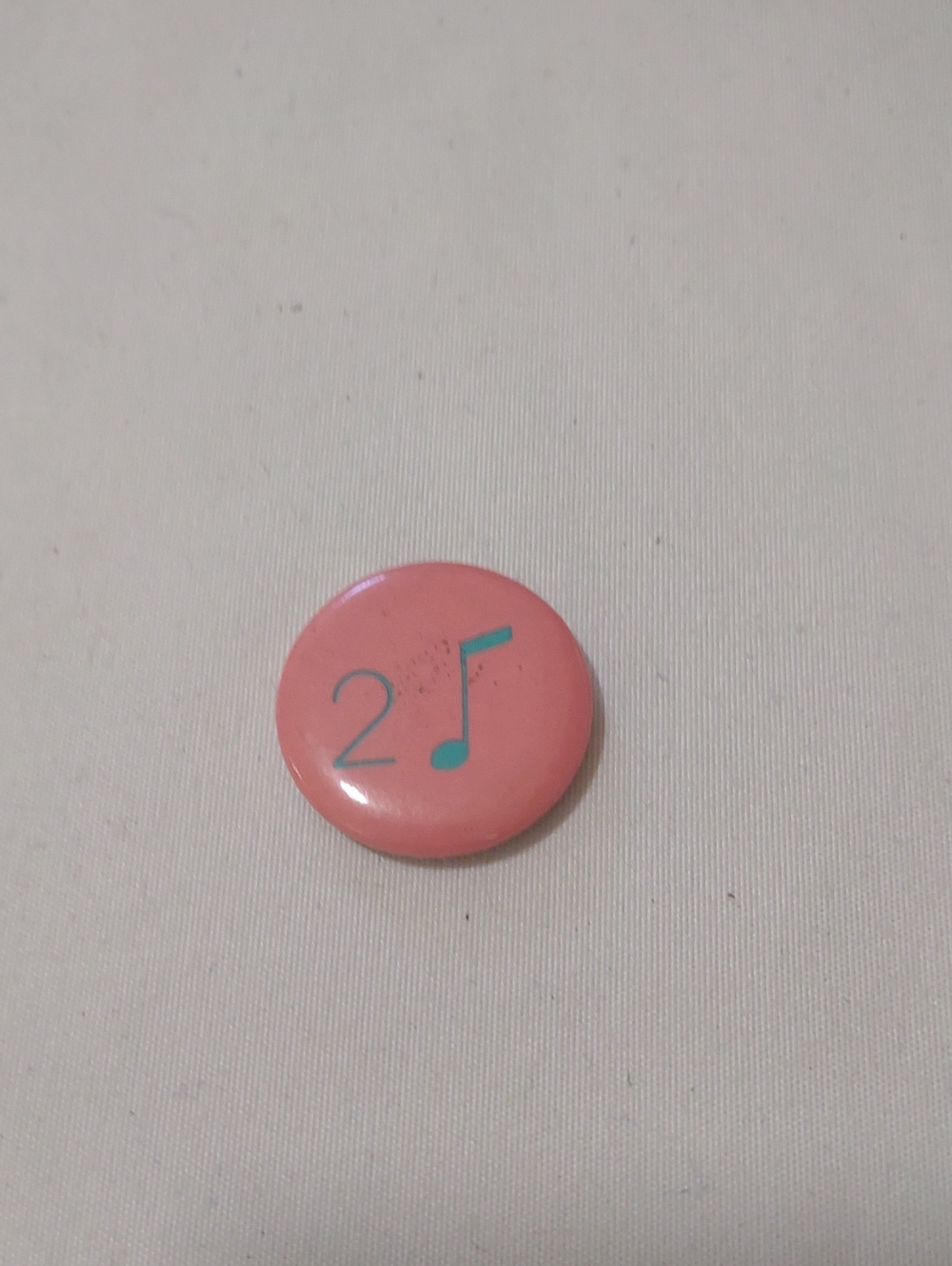 A Music Note and Numeral Design Button Pin